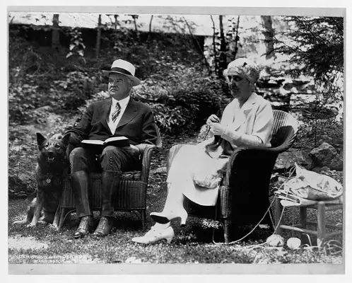 President Herbert Hoover and First Lady Lou Henry Hoover relax in a garden.