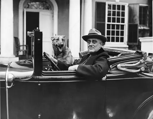 Portrait of American President Franklin Delano Roosevelt (1882 - 1945) as he sits behind the wheel of his car outside of his home in Hyde Park, New York, mid 1930s