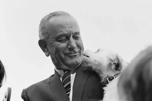 US president Lyndon B Johnson (1908 - 1973) introduces his pet dog Yuki at a Country Fair on the South Lawn of the White House, Washington, DC, September 1967.