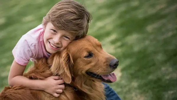 Portrait of a happy boy outdoors with a beautiful dog - lifestyle concepts