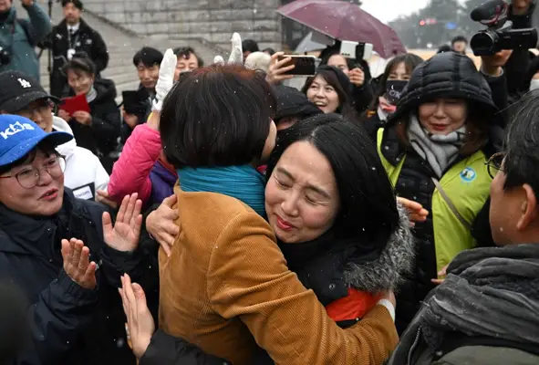 South Korean lawmaker Han Jeong-ae (centre L) celebrates with animal rights activists during a rally welcoming a bill banning dog meat trade at the National Assembly in Seoul on January 9, 2024. South Korea