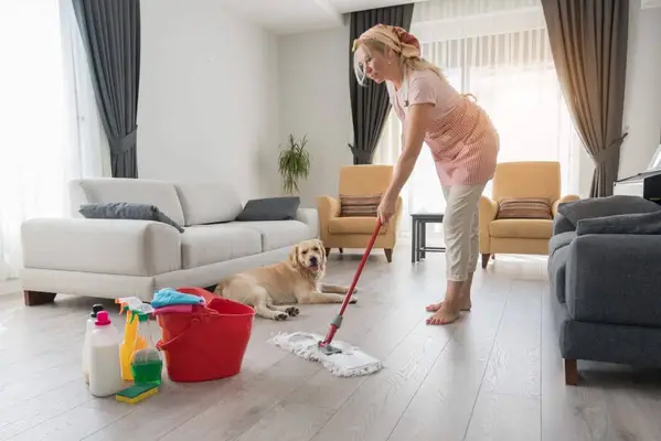 Woman mopping the floor with pet safe cleaning products and disinfectants that won